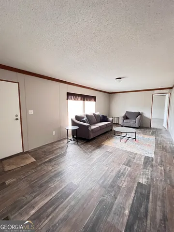 a living room with furniture and a mirror