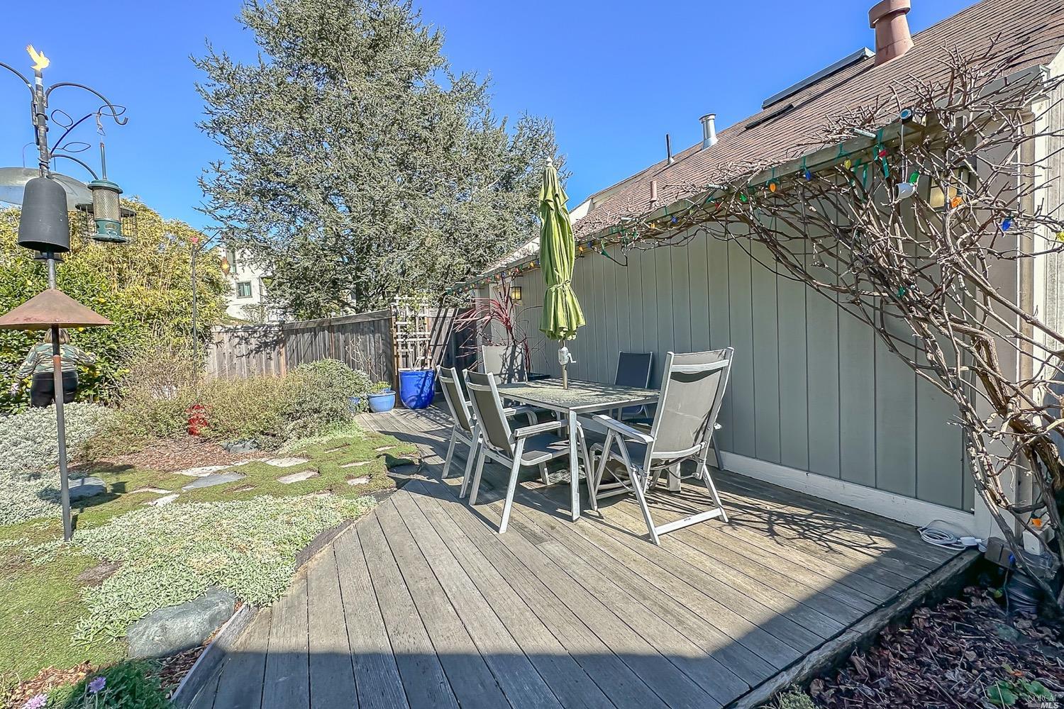 432 Durant Way Mill Valley, CA 94941 - Photo 5 of 69 a view of a roof deck with table and chairs with wooden floor and fence
