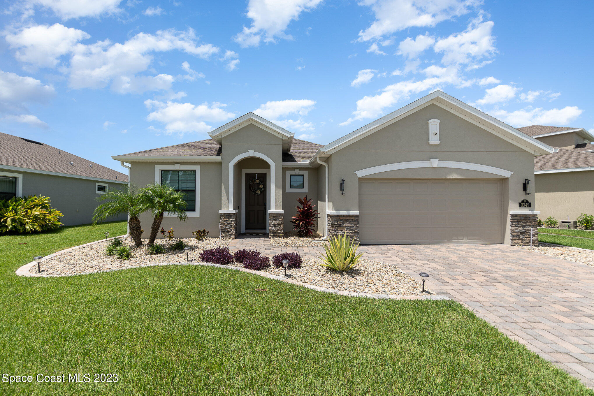 3349 Ribbon Grass Drive Melbourne, FL 32940 - Photo 1 of 45 a front view of a house with a garden and yard
