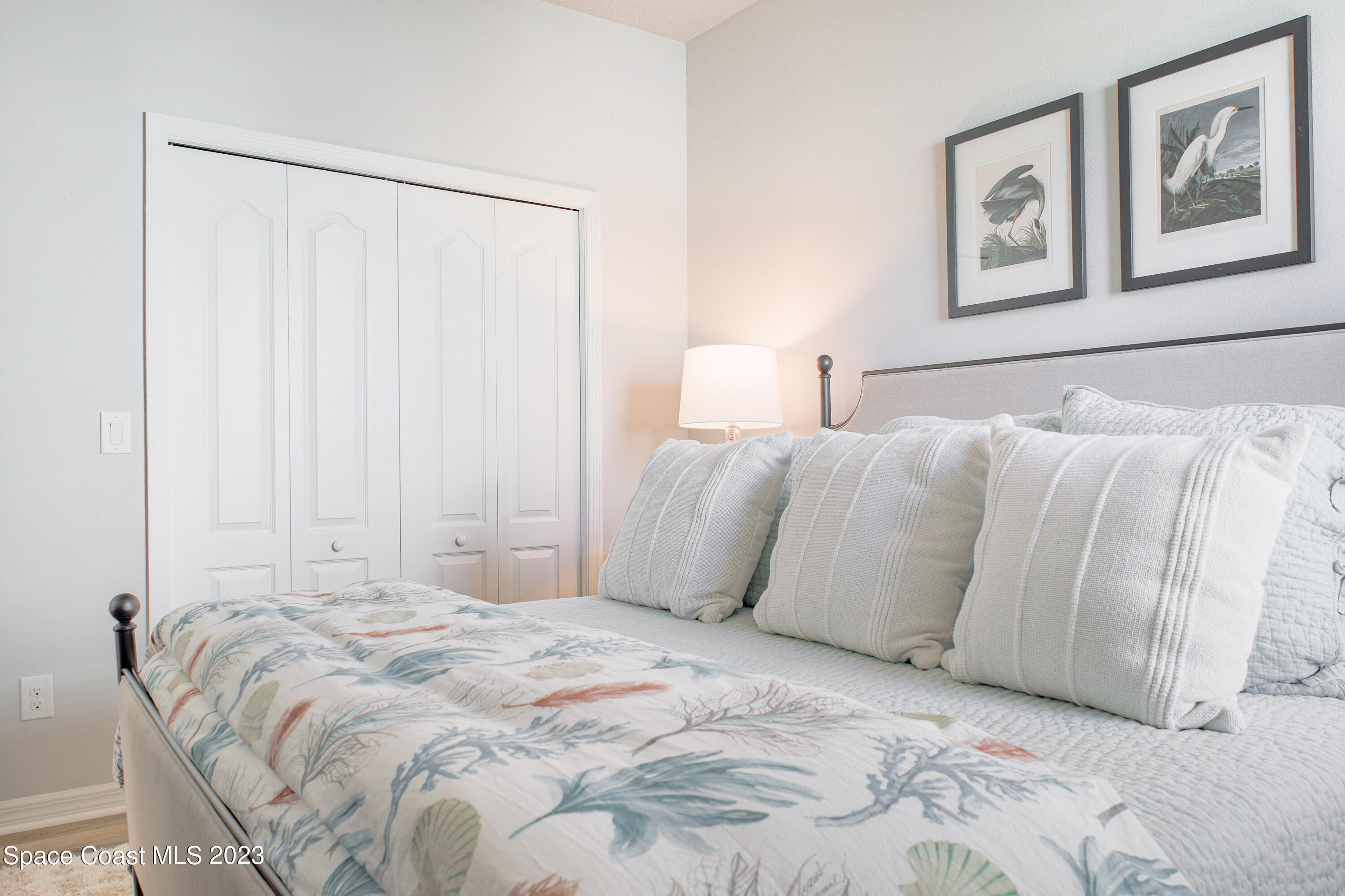 3349 Ribbon Grass Drive Melbourne, FL 32940 - Photo 13 of 45 a large bed sitting in a bedroom next to a lamp