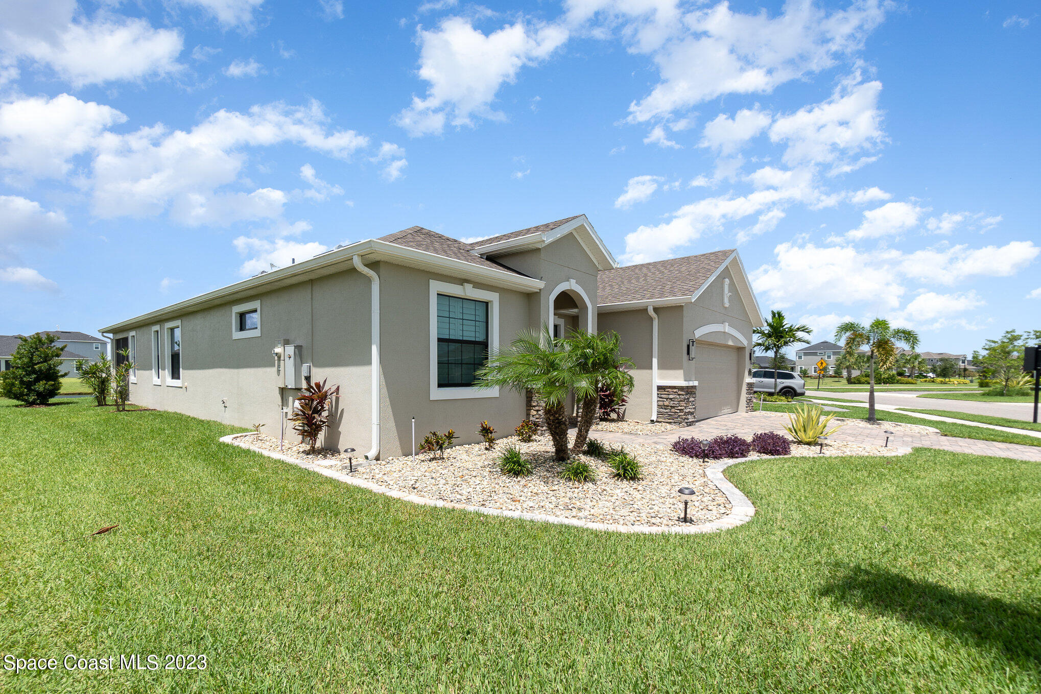 3349 Ribbon Grass Drive Melbourne, FL 32940 - Photo 28 of 45 a front view of house with garden and patio