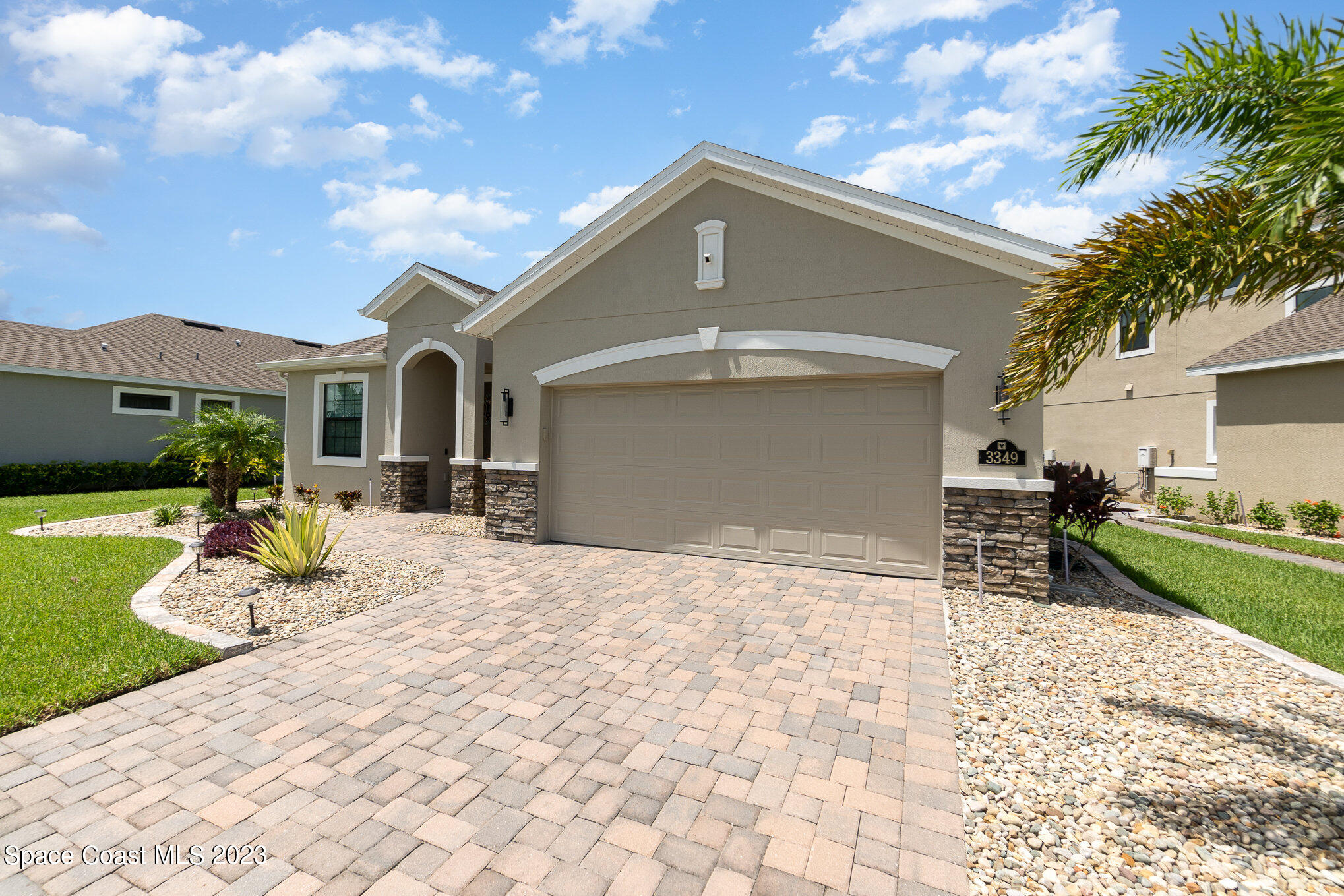 3349 Ribbon Grass Drive Melbourne, FL 32940 - Photo 29 of 45 a front view of a house with a yard and garage