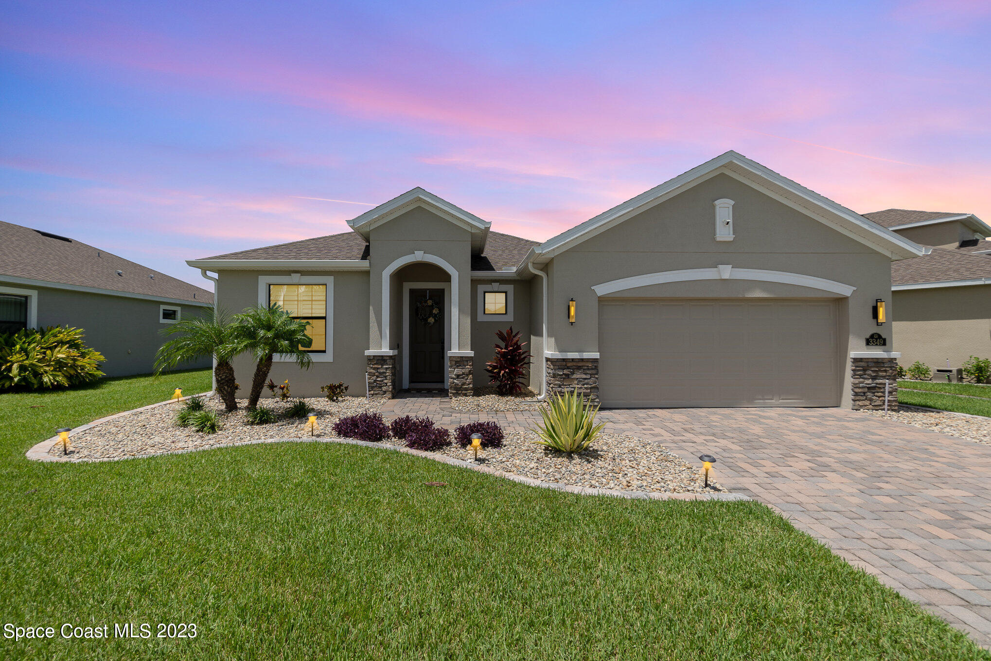 3349 Ribbon Grass Drive Melbourne, FL 32940 - Photo 30 of 45 a front view of a house with a garden and patio