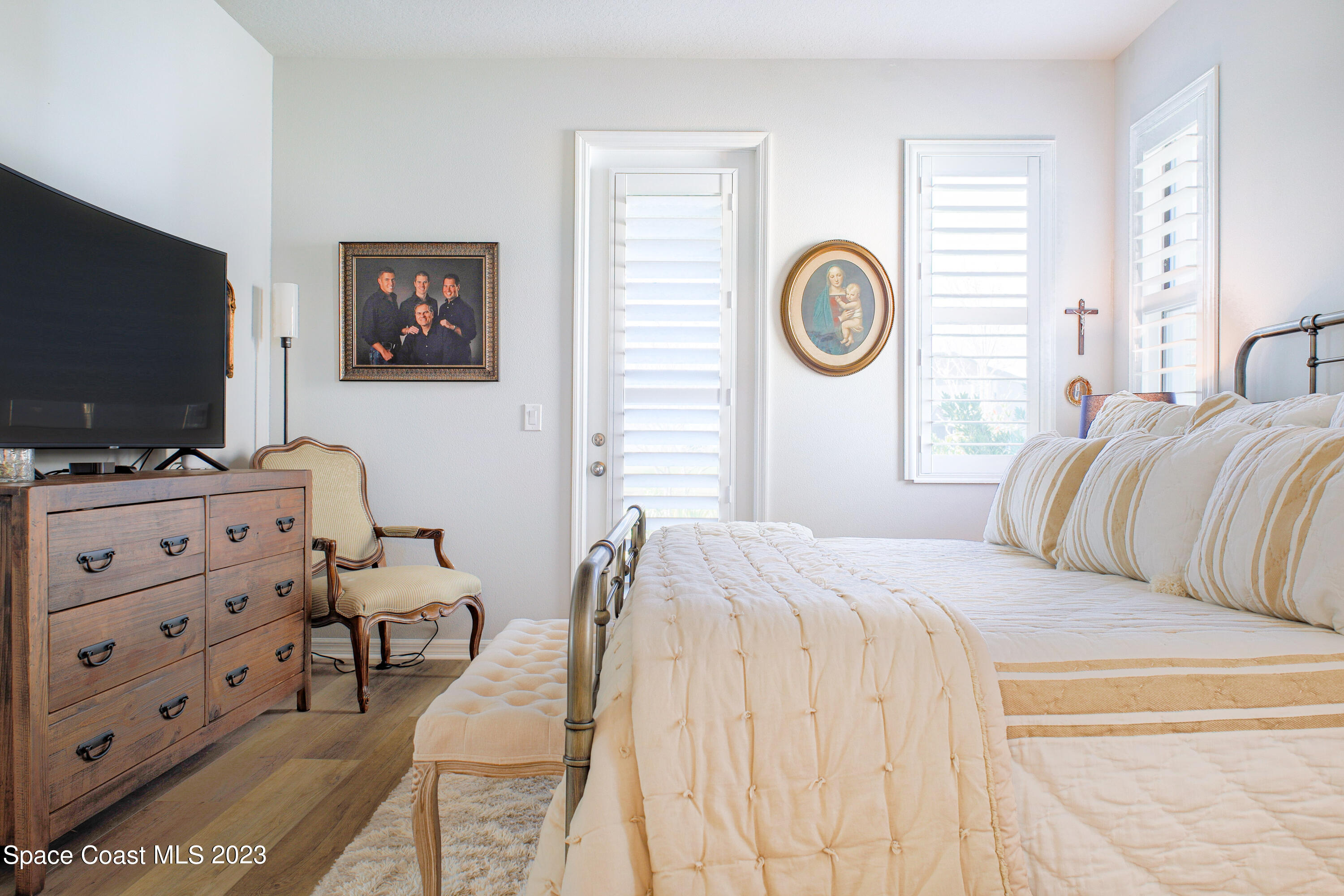 3349 Ribbon Grass Drive Melbourne, FL 32940 - Photo 7 of 45 a bedroom with a bed and a flat screen tv