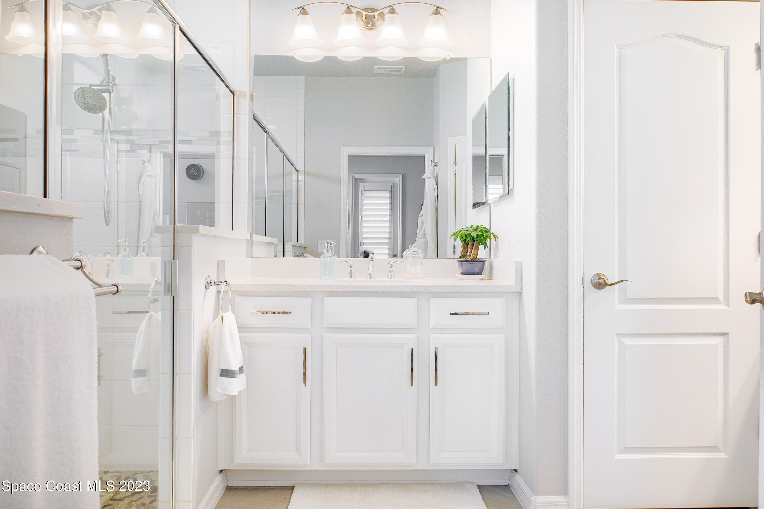 3349 Ribbon Grass Drive Melbourne, FL 32940 - Photo 10 of 45 a bathroom with a sink vanity and a mirror