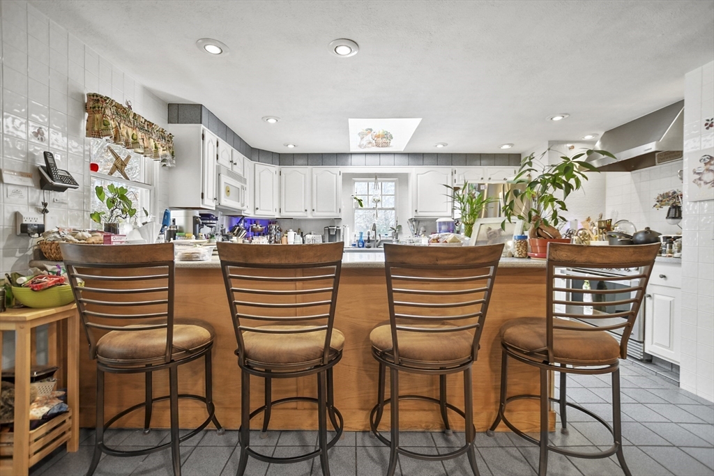 264 John Parker Road Falmouth, MA 02536 - Photo 11 of 41 a dining hall with stainless steel appliances a dining table and chairs with wooden floor