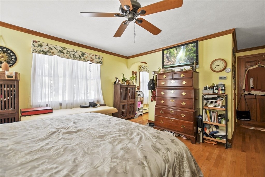 264 John Parker Road Falmouth, MA 02536 - Photo 19 of 41 a bedroom with a bed and a chandelier