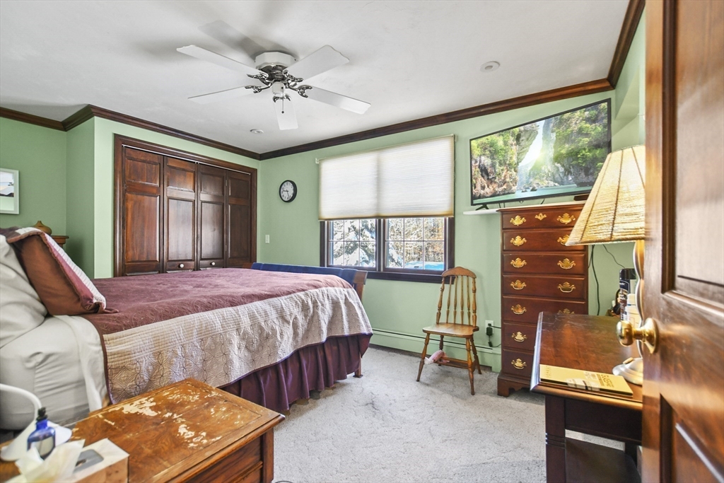 264 John Parker Road Falmouth, MA 02536 - Photo 24 of 41 a bedroom with a bed a chandelier and a window