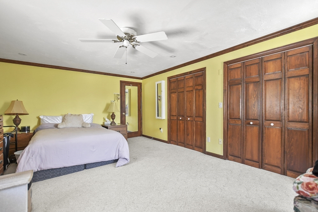 264 John Parker Road Falmouth, MA 02536 - Photo 28 of 41 a bedroom with a bed and a chandelier