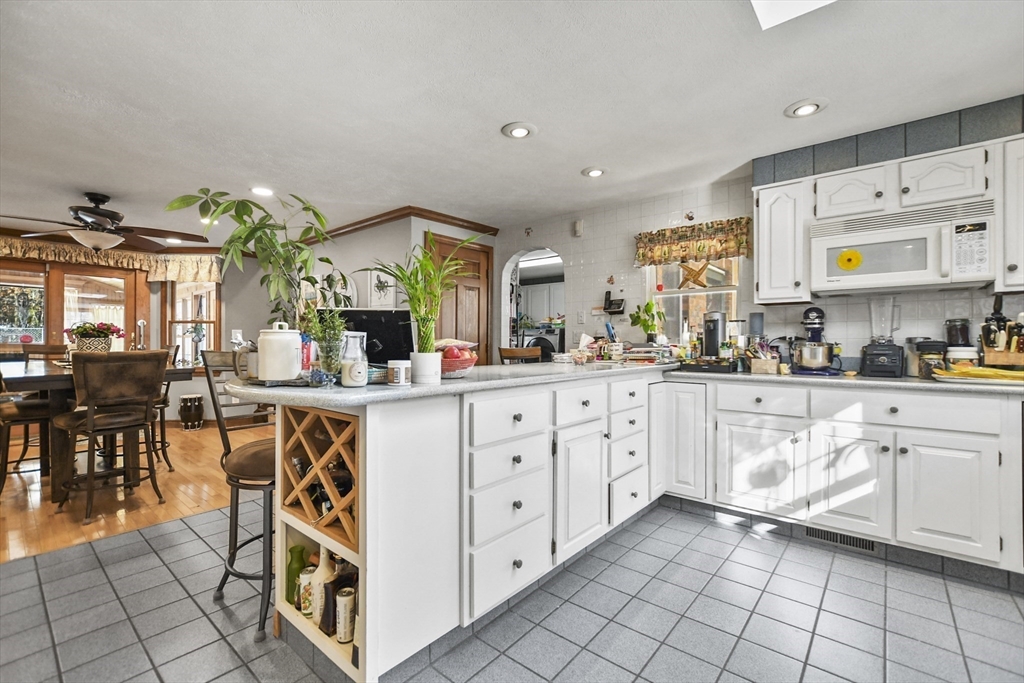 264 John Parker Road Falmouth, MA 02536 - Photo 3 of 41 a kitchen with stainless steel appliances a white stove top oven cabinets a stove and a window