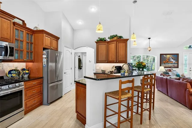 a kitchen with stainless steel appliances granite countertop a stove and a microwave