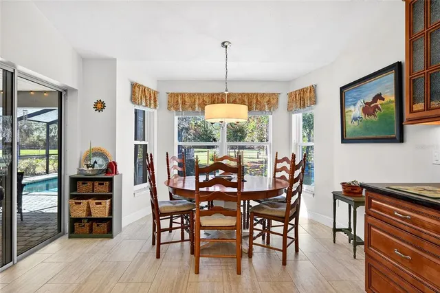 a kitchen with stainless steel appliances granite countertop a refrigerator a sink a stove and a refrigerator