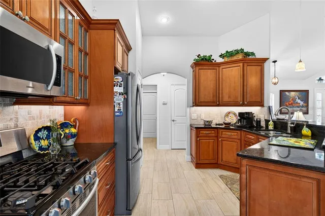 a view of a hallway with wooden floor and entryway