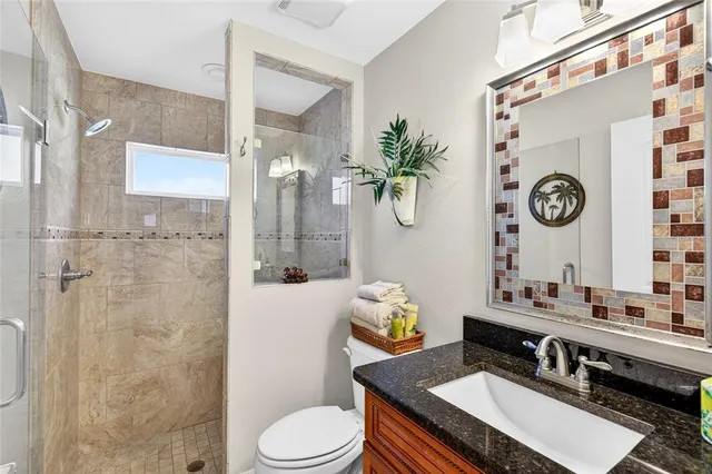 a dining room with furniture a large window and a rug
