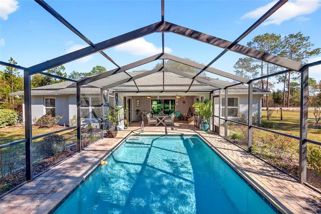 a front view of a house with swimming pool having outdoor seating