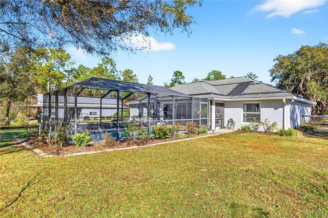 a view of a swimming pool with a yard