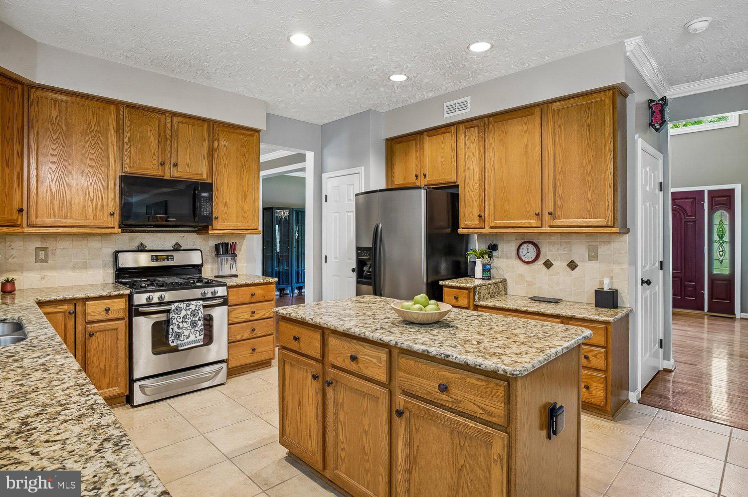 217 Raccoon Run Court Hanover, MD 21076 - Photo 7 of 38 a kitchen with stainless steel appliances granite countertop a stove refrigerator and microwave
