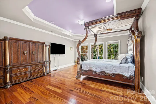 a bed room with a bed and a television