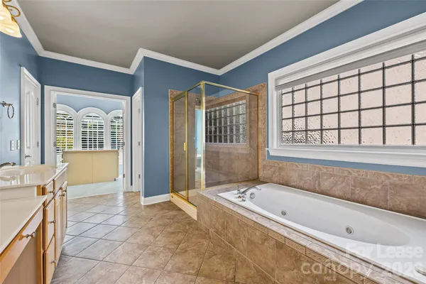 a spacious bathroom with a granite countertop tub and a sink