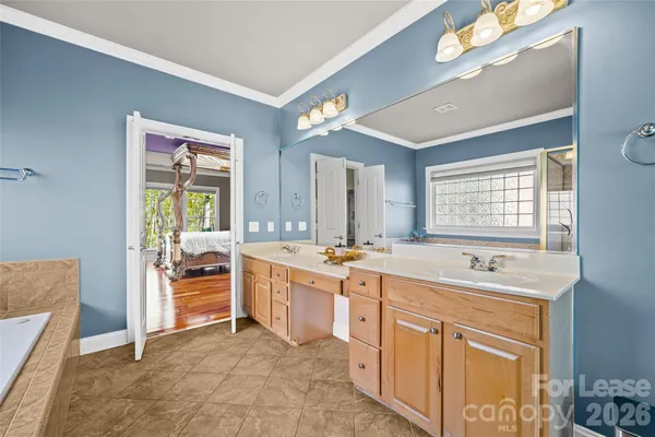 a large bathroom with a large tub sink and double vanity