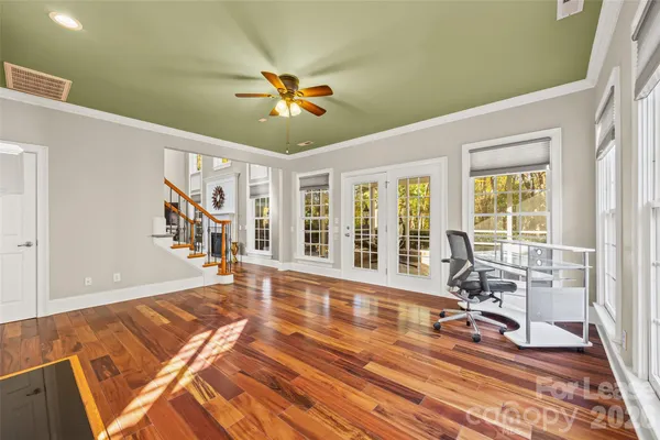 a view of a livingroom with wooden floor and furniture