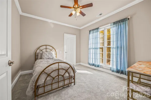 a bedroom with a bed a window and closet
