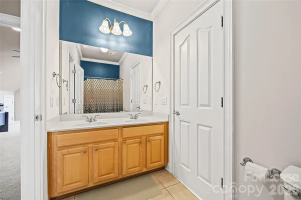 a spacious bathroom with a double vanity sink and a mirror