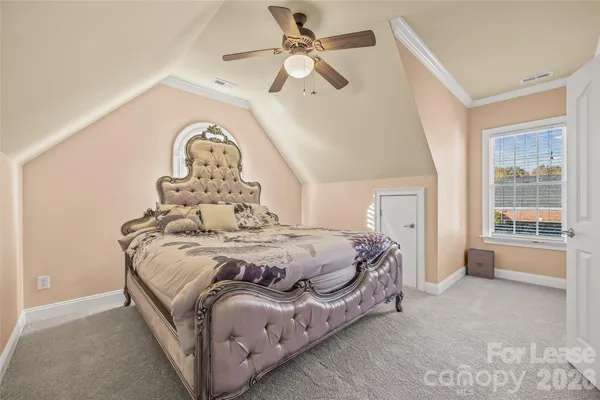 a spacious bedroom with a bed and a large window