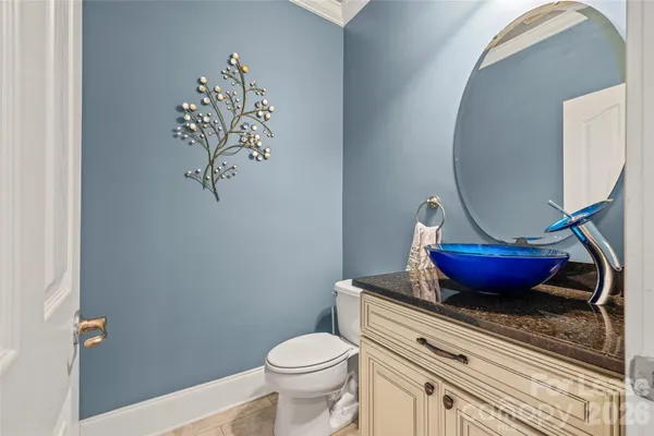 a bathroom with a toilet and a mirror
