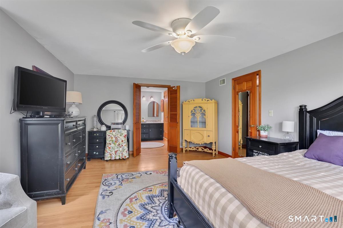 72 Old Post Road Wethersfield, CT 06109 - Photo 18 of 40 a bedroom with a bed a flat screen tv and dresser