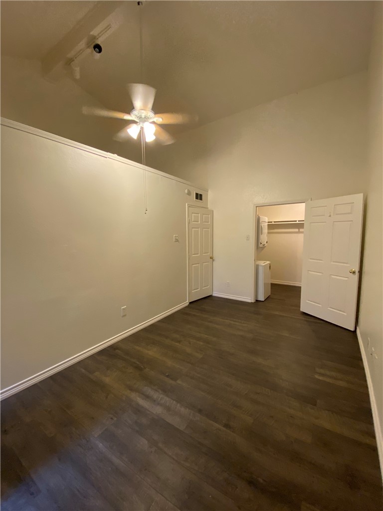 2401 Leon Street, Unit 206 Austin, TX 78705 - Photo 13 of 16 a view of a livingroom with a chandelier fan and wooden floor