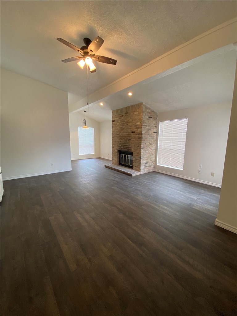 2401 Leon Street, Unit 206 Austin, TX 78705 - Photo 4 of 16 an empty room with wooden floor ceiling fan and window