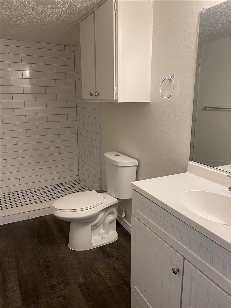 2401 Leon Street, Unit 206 Austin, TX 78705 - Photo 7 of 16 a white toilet sitting next to a bathroom sink