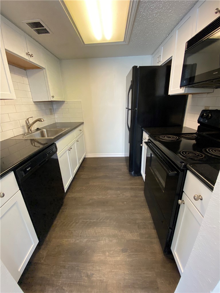 2401 Leon Street, Unit 206 Austin, TX 78705 - Photo 8 of 16 a kitchen that has a sink and a stove