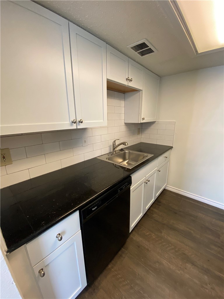2401 Leon Street, Unit 206 Austin, TX 78705 - Photo 9 of 16 a kitchen with granite countertop a sink a stove and cabinets