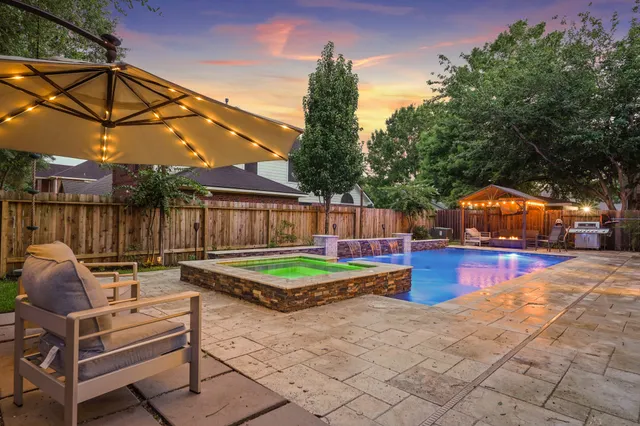 a view of backyard with furniture and a tub