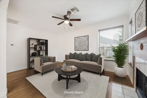 a living room with furniture and a potted plant
