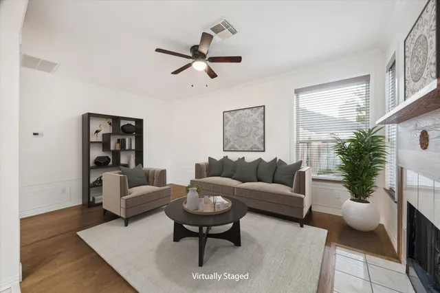 a living room with furniture and a potted plant