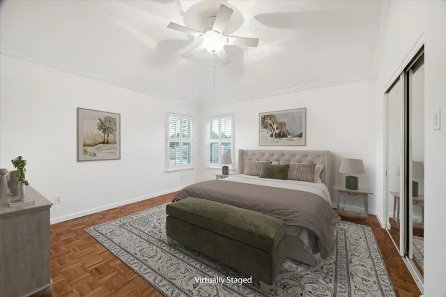 a bedroom with a large bed and a chandelier