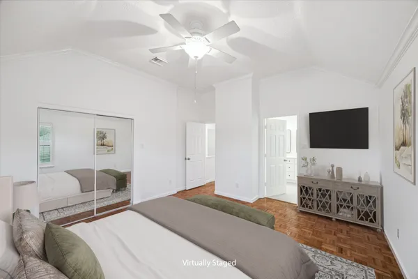 a bedroom with a bed and a flat screen tv