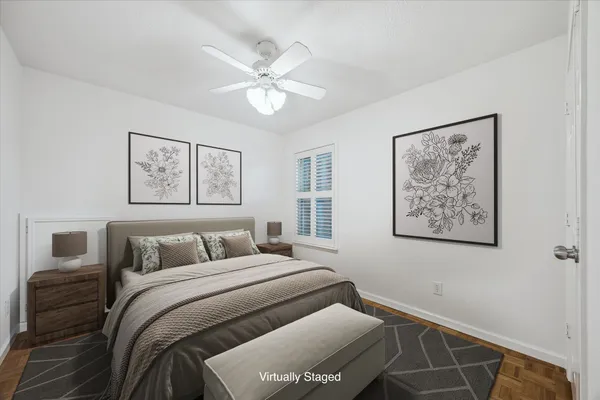 a bedroom with a bed and a painting on the wall