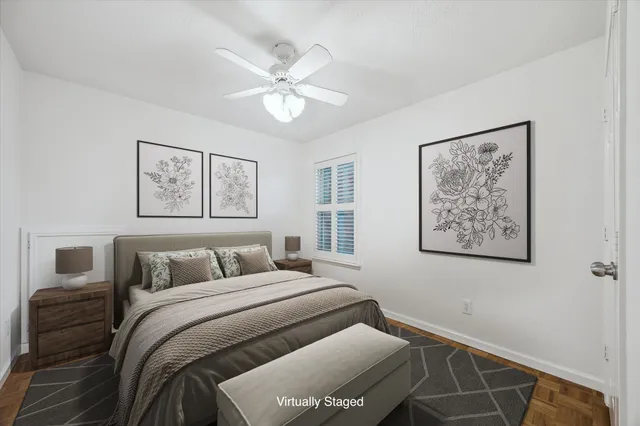 a bedroom with a bed and a painting on the wall