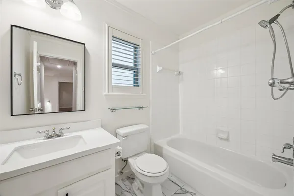 a bathroom with a sink toilet a mirror and shower