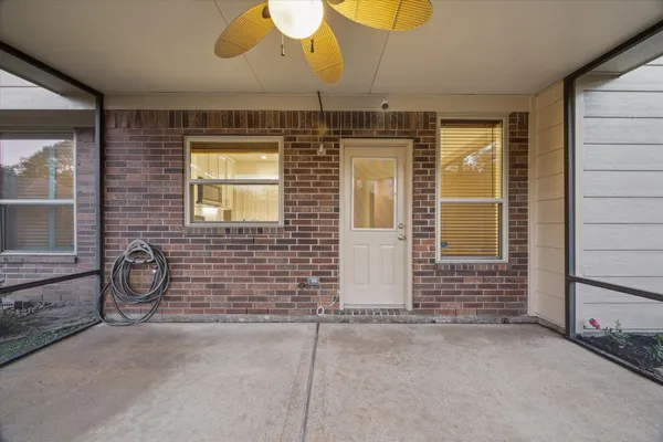 a view of a door with a chair and a window