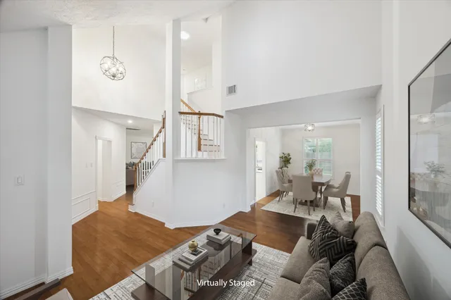 a living room with furniture and wooden floor