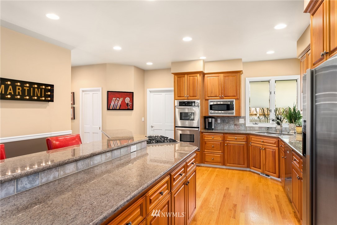 21731 35th Avenue Southeast Bothell, WA 98021 - Photo 11 of 36 a large kitchen with stainless steel appliances granite countertop a large window and cabinets
