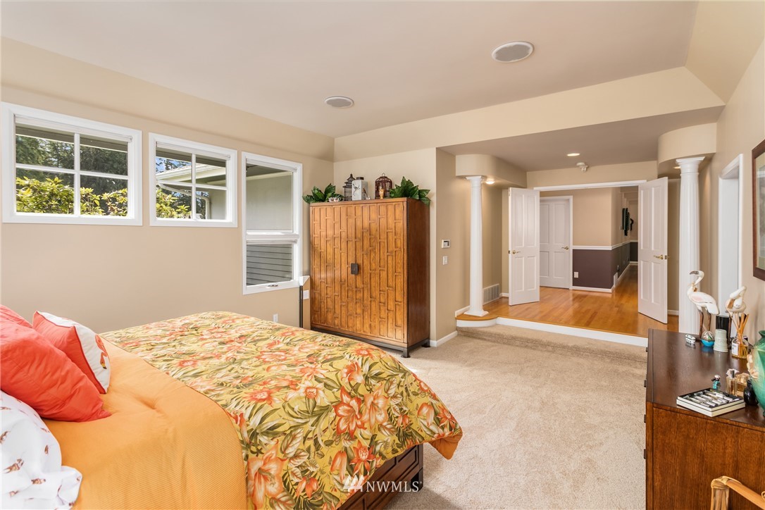 21731 35th Avenue Southeast Bothell, WA 98021 - Photo 16 of 36 a spacious bedroom with a bed and a large window