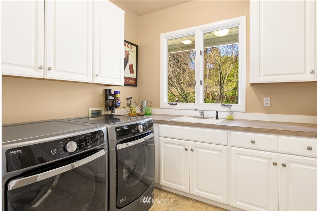 21731 35th Avenue Southeast Bothell, WA 98021 - Photo 22 of 36 a kitchen with white cabinets and a stove top oven