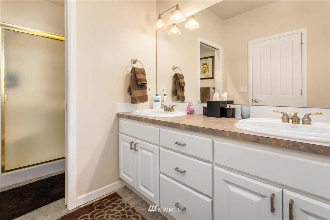 21731 35th Avenue Southeast Bothell, WA 98021 - Photo 25 of 36 a bathroom with double sink and a mirror