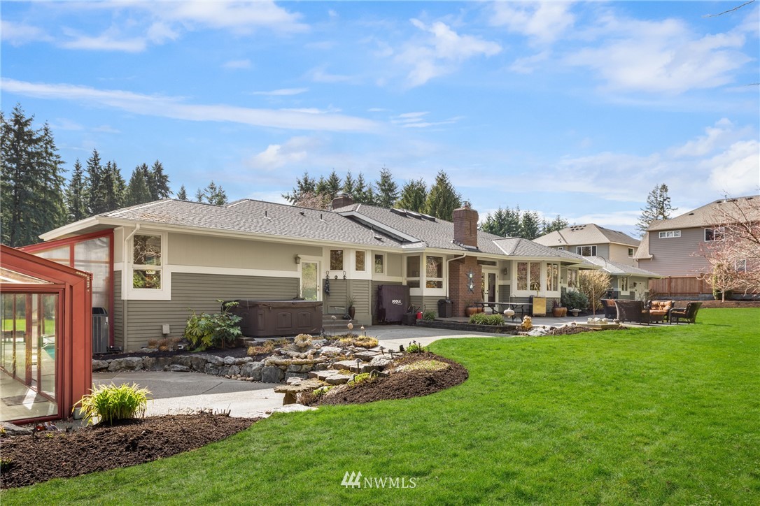 21731 35th Avenue Southeast Bothell, WA 98021 - Photo 34 of 36 a front view of a house with a garden and trees